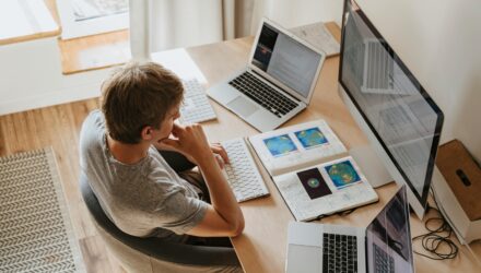 Man working on computer at home desk