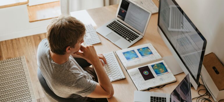 Man working on computer at home desk