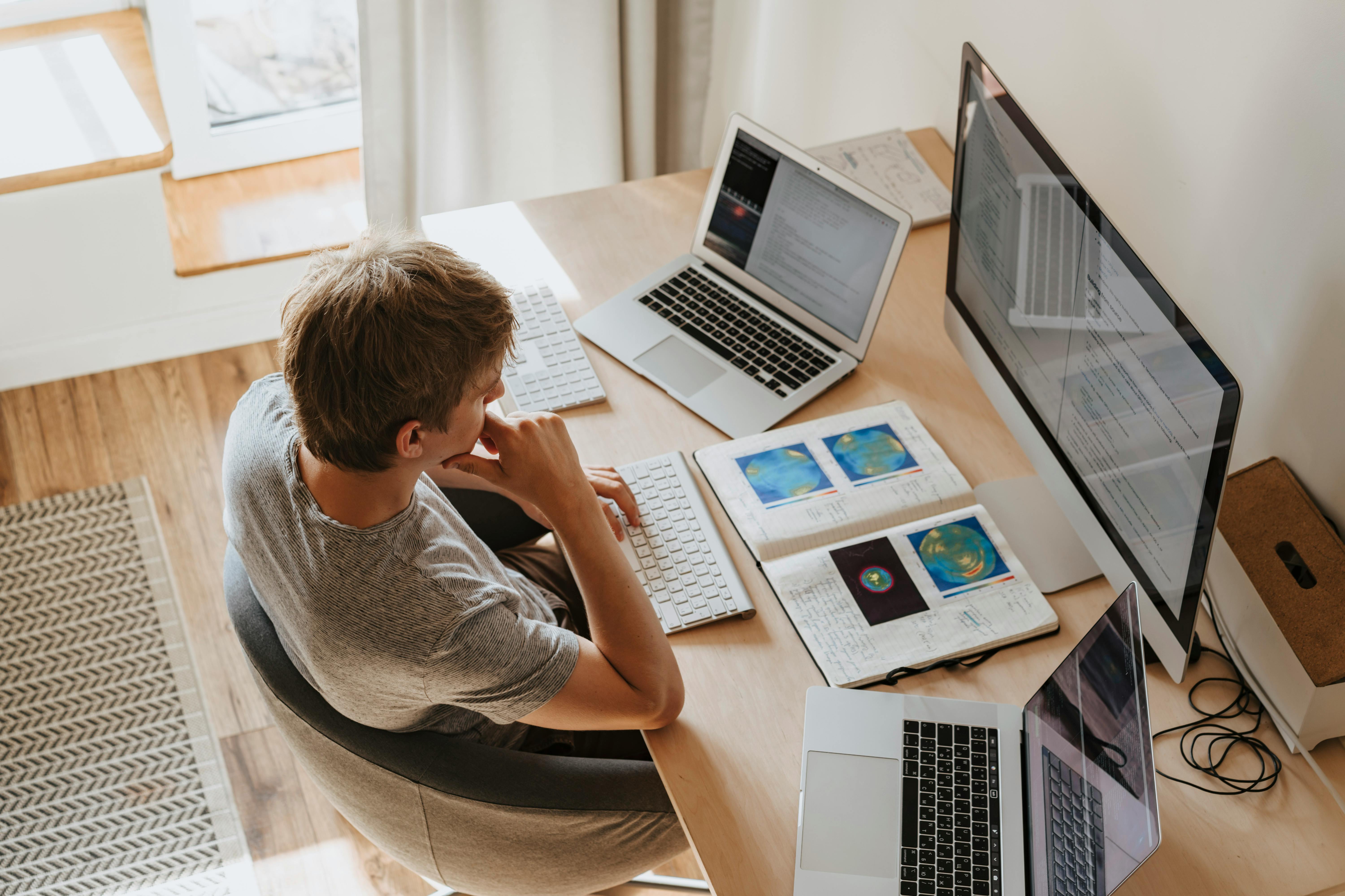 Man working on computer at home desk